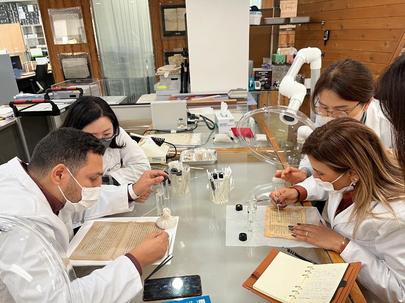 Restoration staff from Archives du Maroc (Archives of Morocco) in November 2023 practice removing vinyl tape at the National Archive of Korea's (NAK) branch in Seongnam, Gyeonggi-do Province. (NAK)  